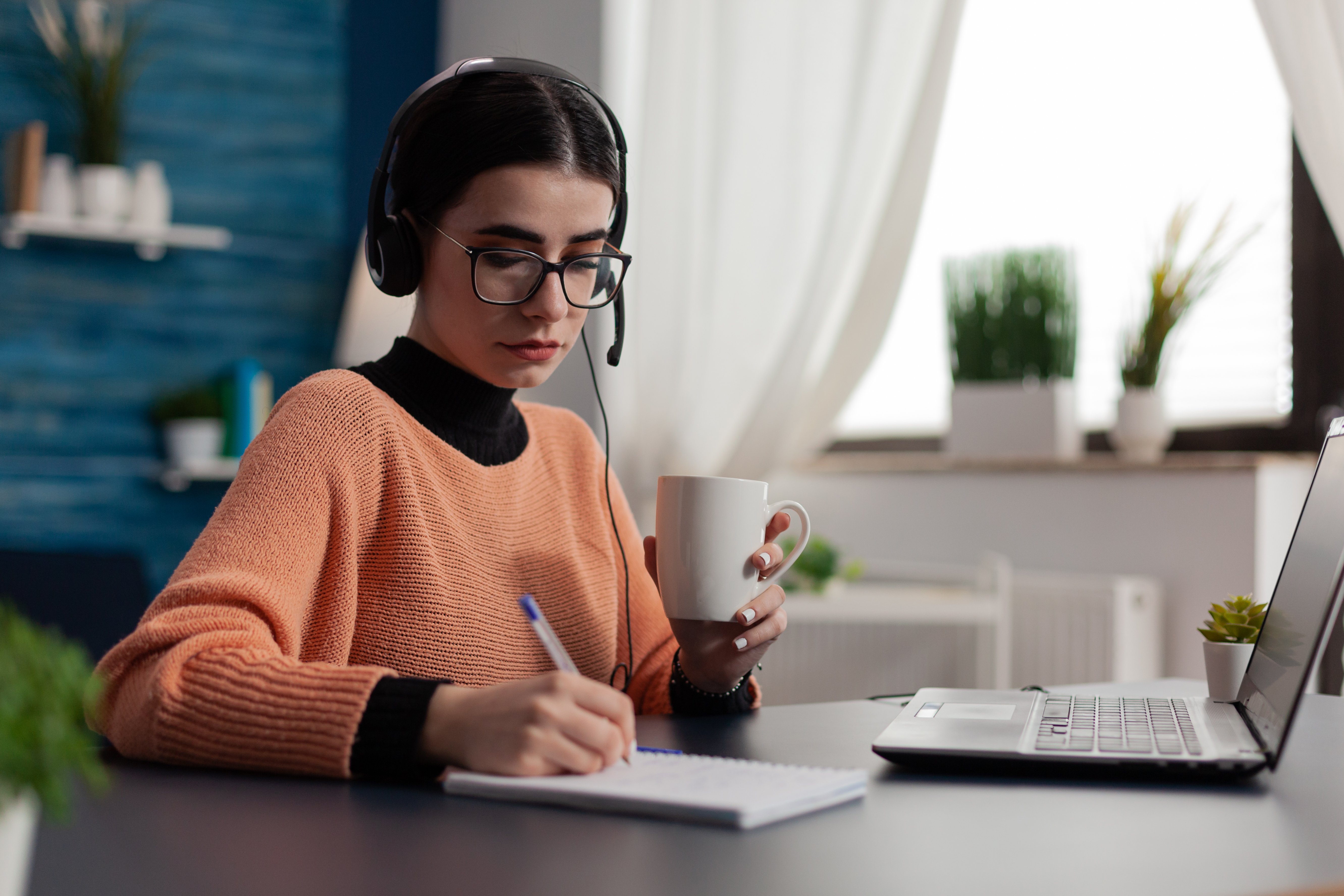student-with-headphones-listening-to-online-course-2022-01-04-23-30-41-utc